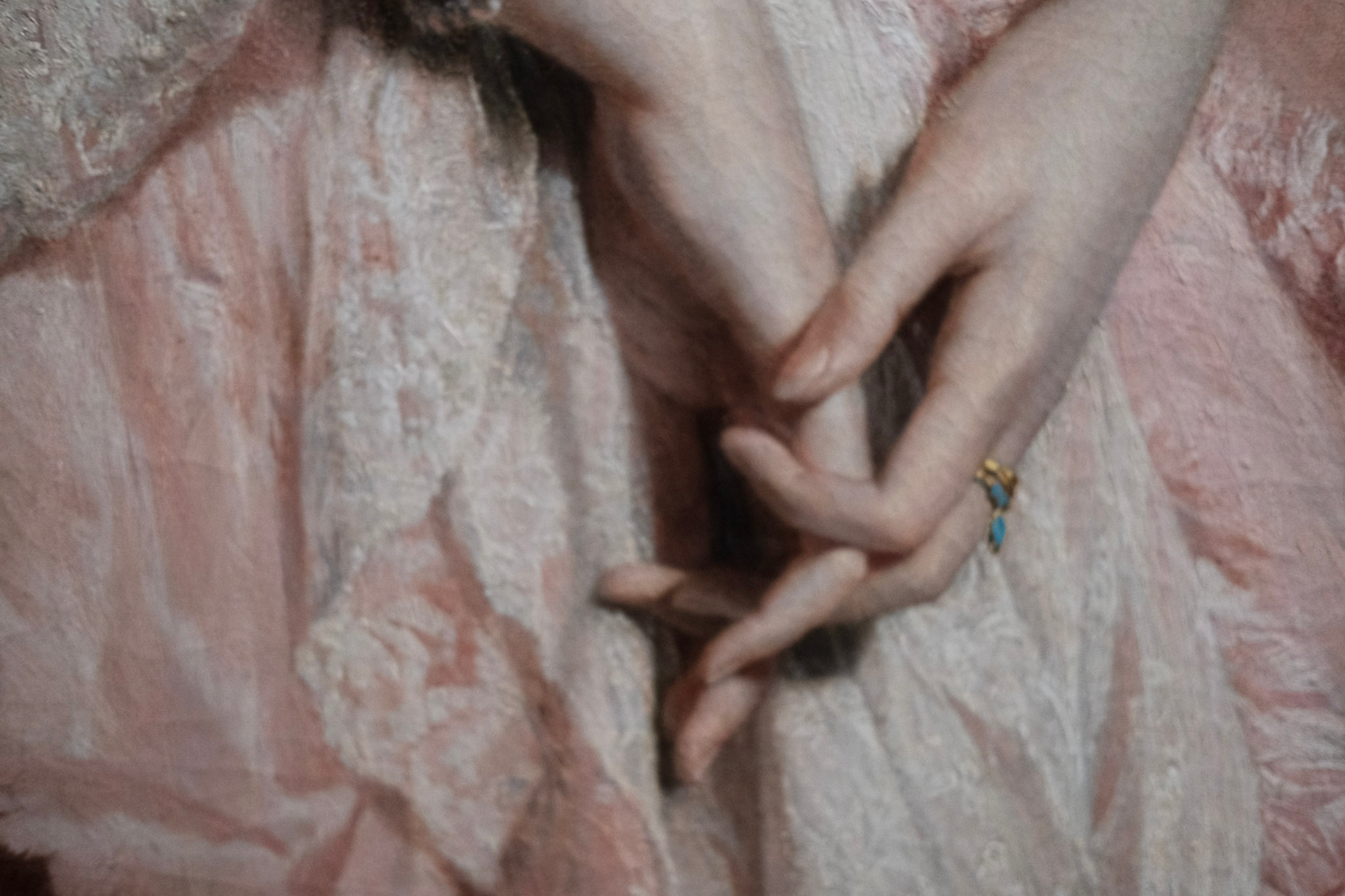 Detail of a painting: outstretched arms and hands against dark drapery